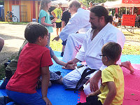 Karate-Trainer sprechen mit Besuchern auf der Mattenfläche am Karate-Stand in Montabaur